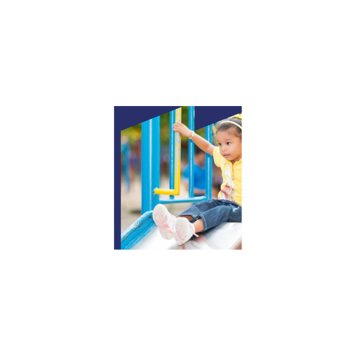 Child sliding down playground equipment slide